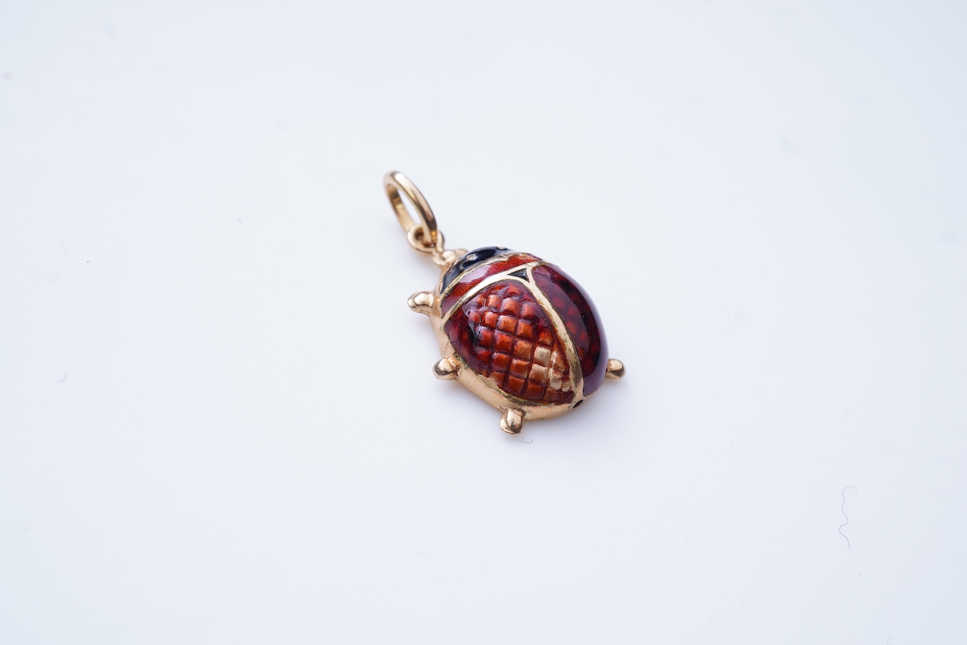 A gold and enamel pendant, Italy, 1960s